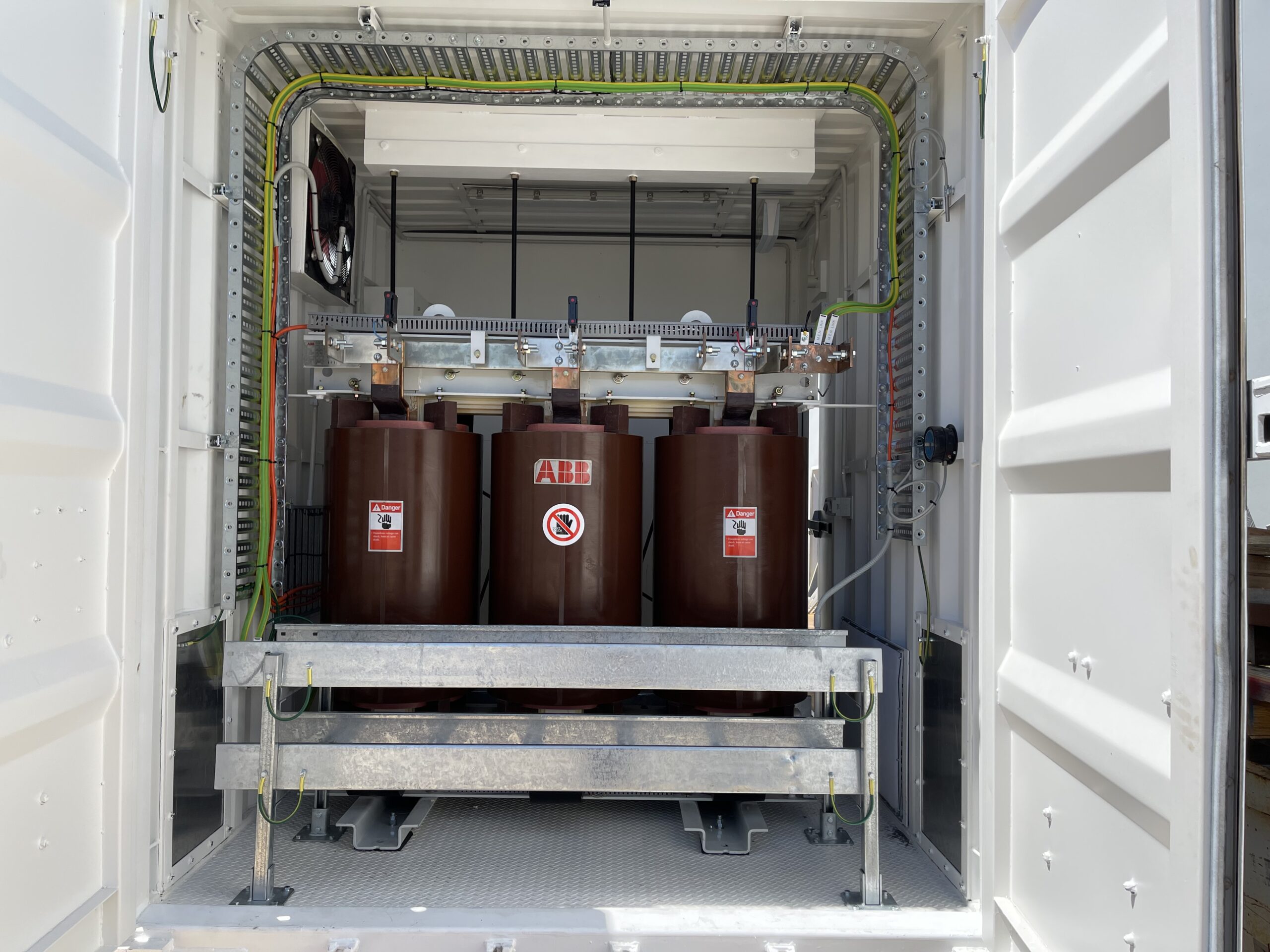 View inside shipping container of ABB dual tap 22/11kV HV 433V LV Dyn11 Dry Try Power Transformers